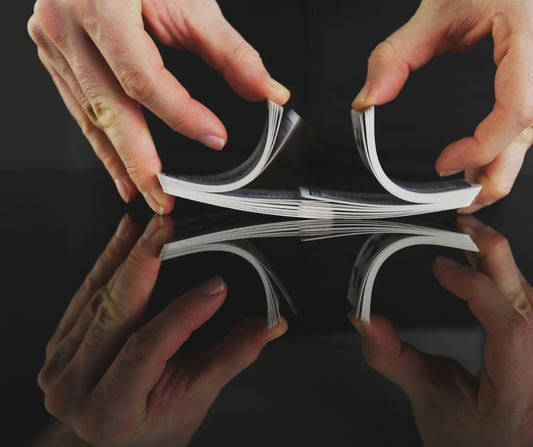 Two hands shuffling a deck of cards